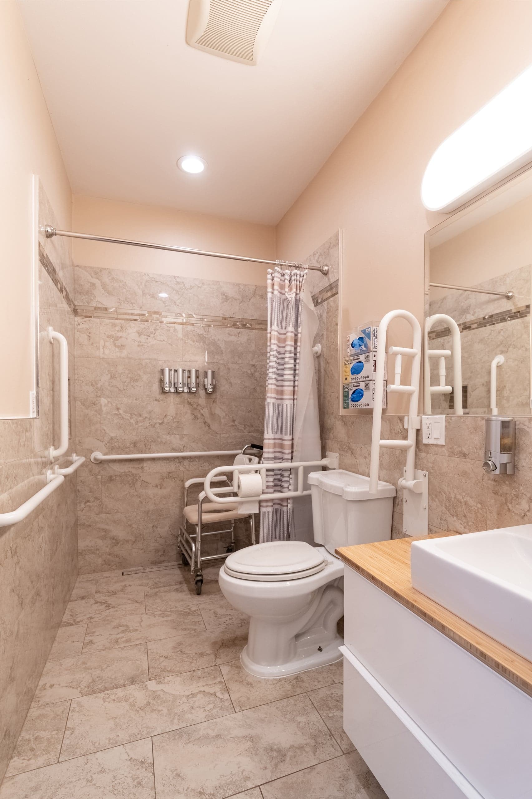 A private bathroom with a wheelchair-accessible shower and a wide doorway.