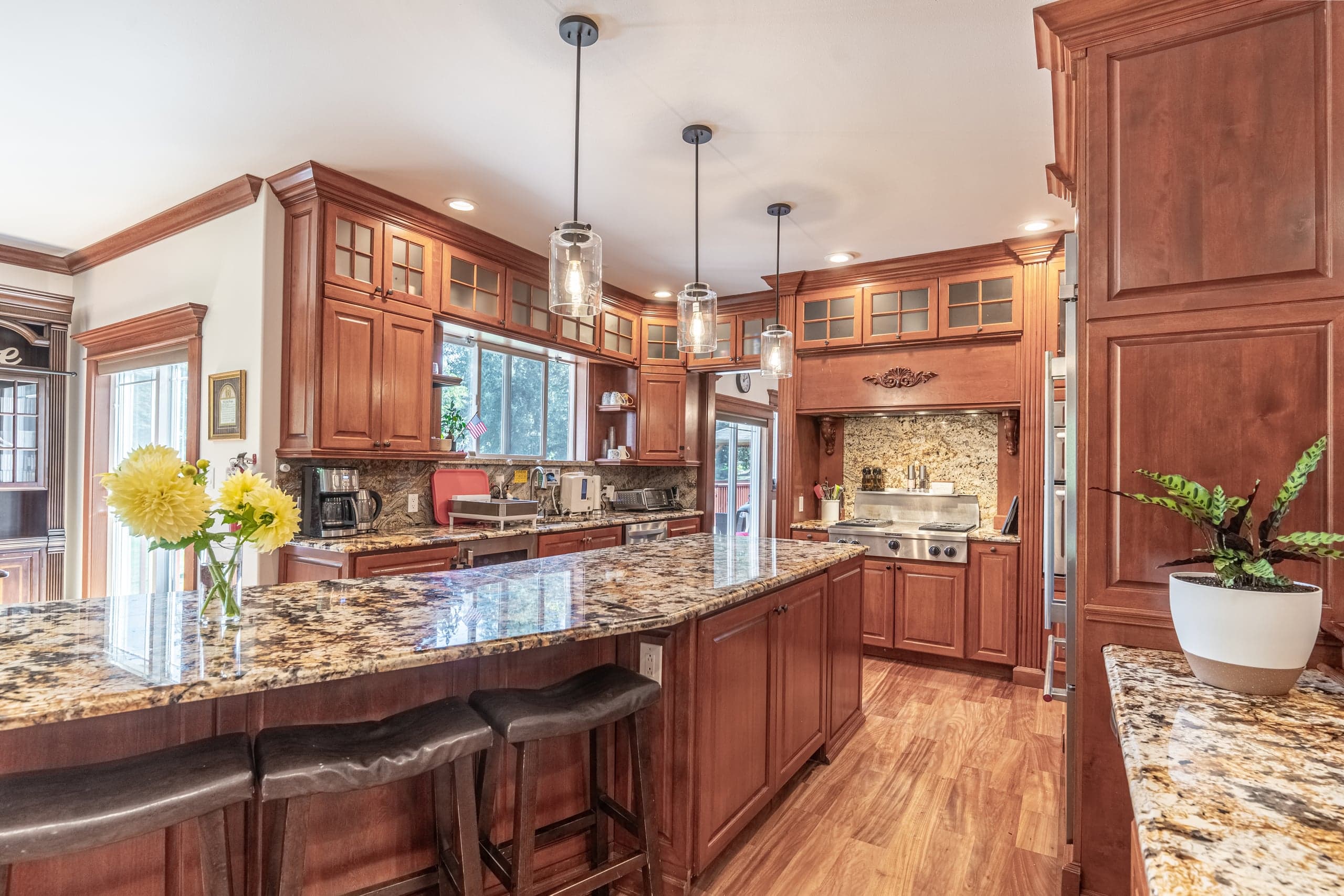 The kitchen, with cherry cabinetry, granite counters and double ovens.