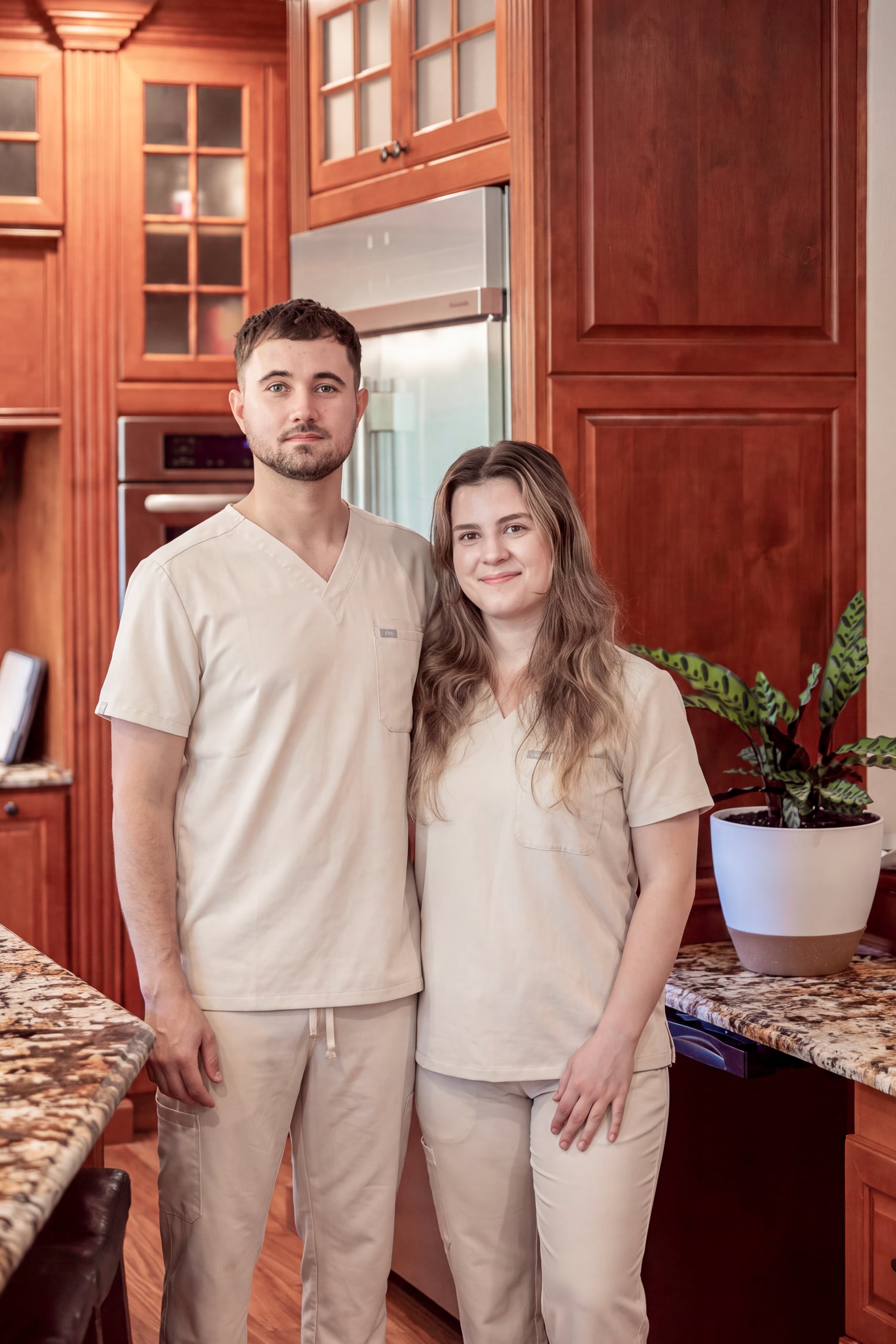 The two owner-caregivers of May Valley Golden Years, standing together in the kitchen of the home.
